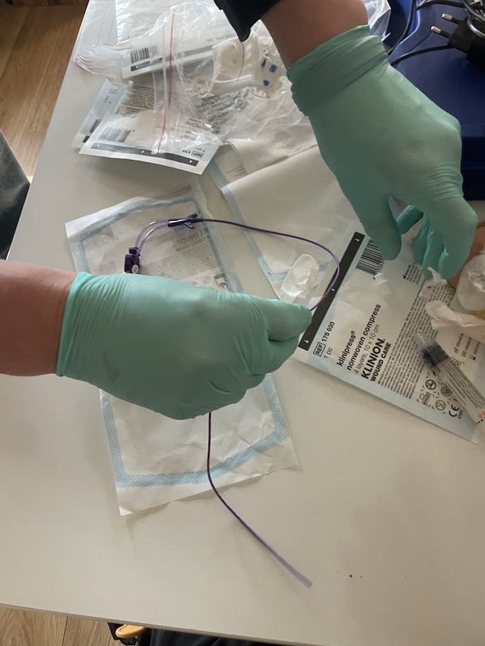 Hands of a nurse handle medical equipment