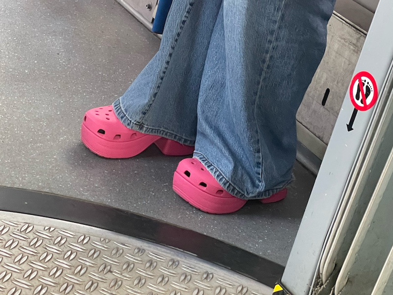 A person on the Amsterdam tram wearing heeled Crocs