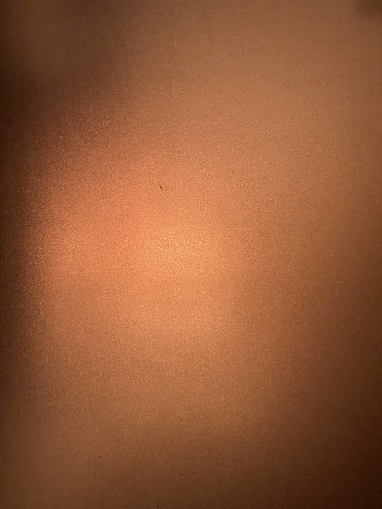A warm dark gradient abstract view created by a night light behind a semitransparent window